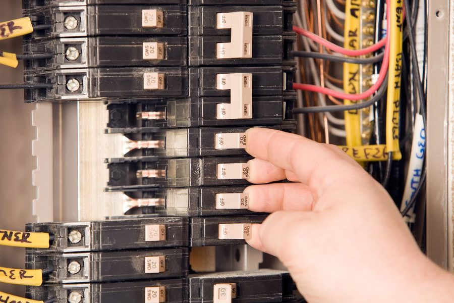 Electrician working on an electrical panel